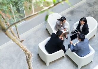 business people sitting in chairs meeting