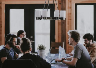 A team of employees sitting around a conference table.