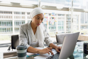 woman working at a computer in a city office.